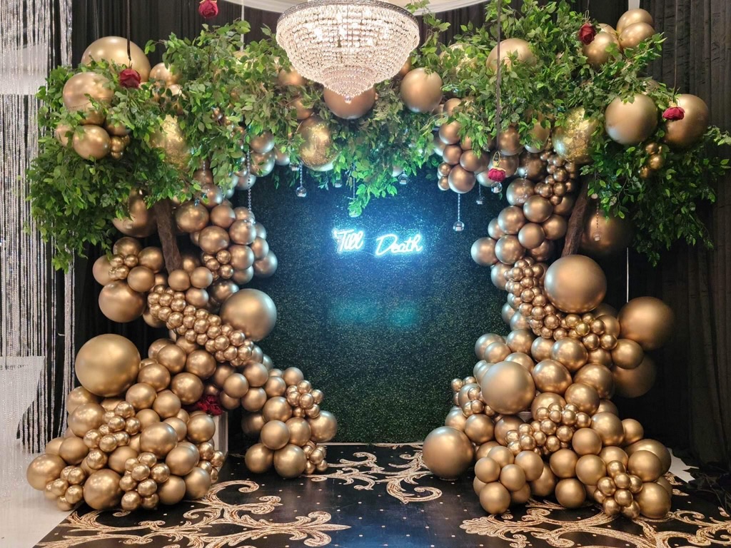 Luxury gold balloon installation with neon sign for special event
